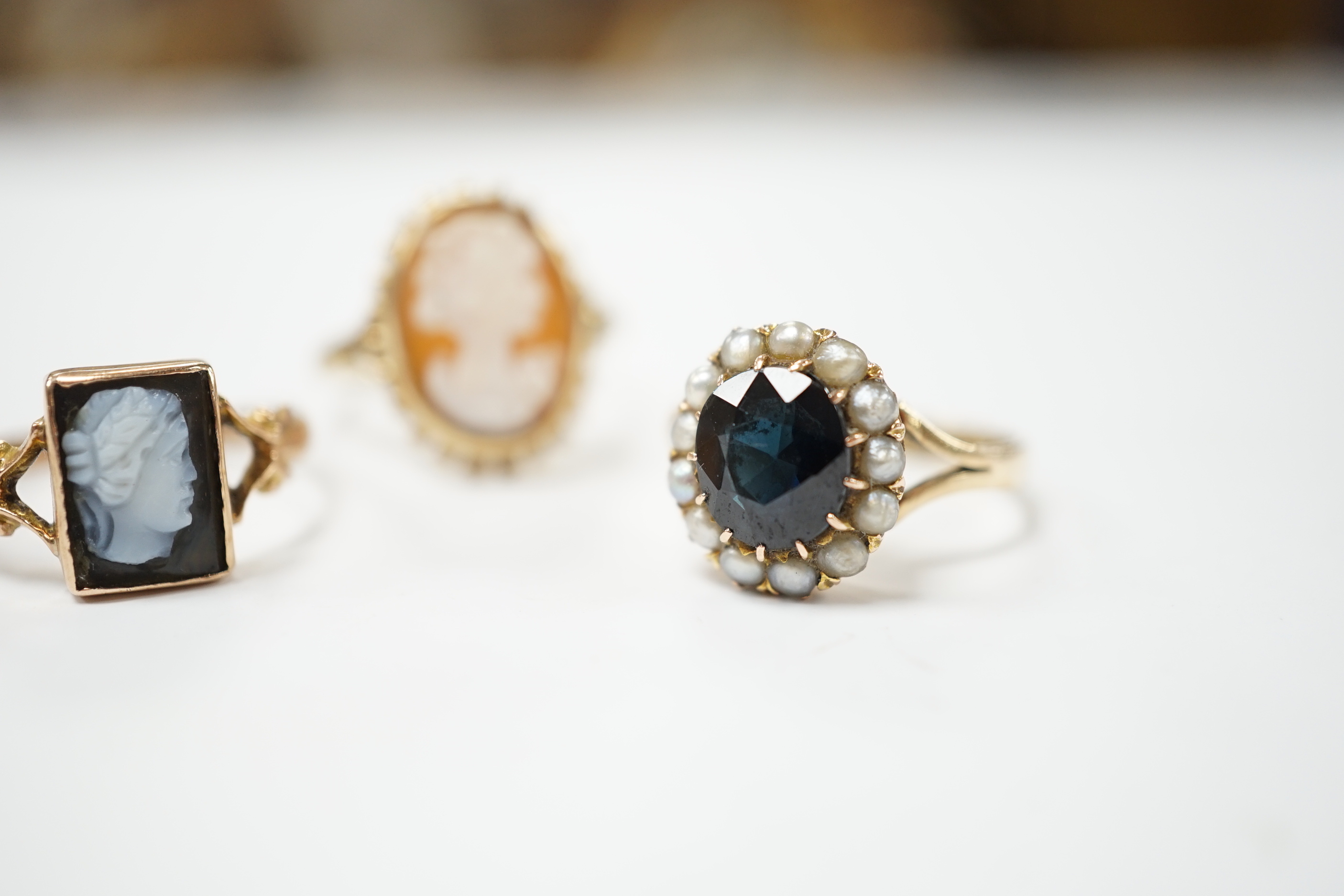 Two 9ct gold cameo rings, size N and Q, and a pearl and sapphire cluster ring, size N